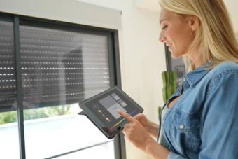 woman uses tablet checking home