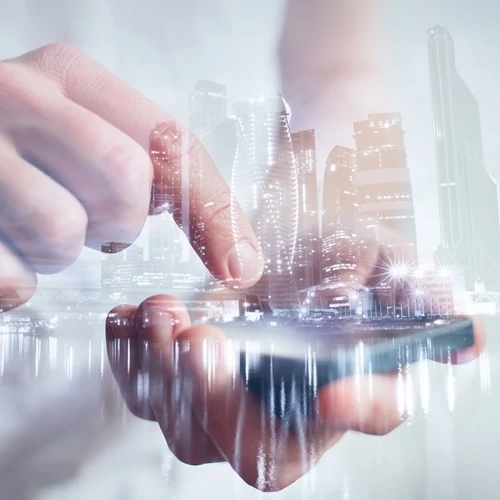 man uses smartphone business buildings background
