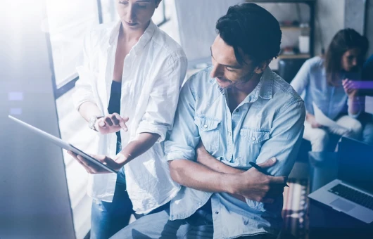 two colleagues working with a tablet