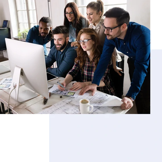 colleagues look at pc screen in office