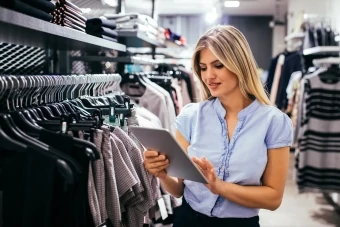 shop assistant with tablet in store