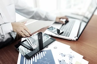 man with tablet uses software in the cloud