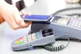 woman pays with a smartphone using contactless technologies
