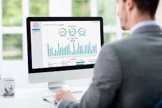 man looking at graphs on pc